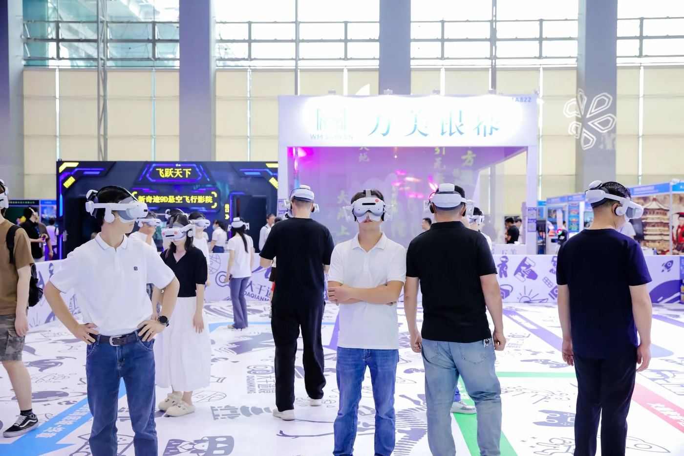 Visitors trying on VR headsets at a technology booth on the exhibition floor.