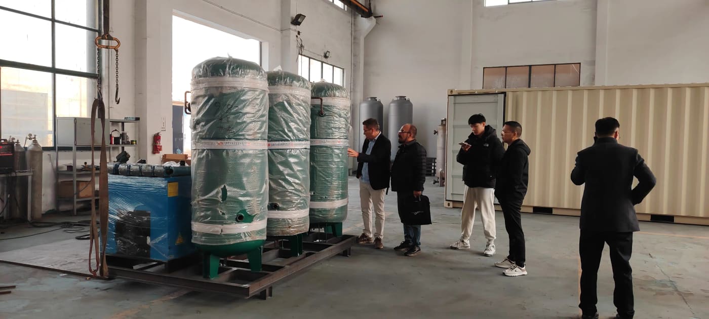 Buyers inspecting shrink-wrapped equipment staged for shipment beside a loading area.
